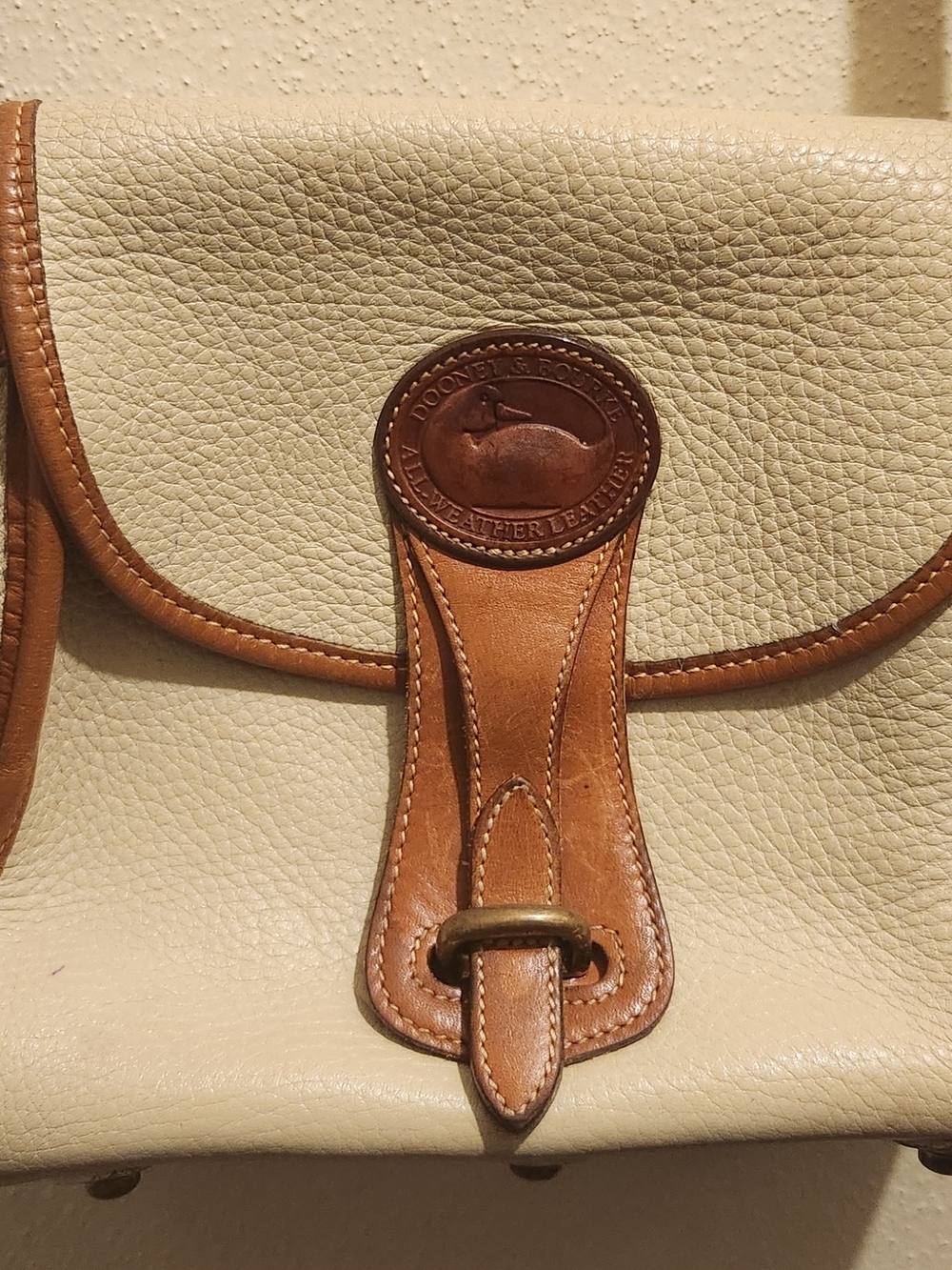 Dooney & Bourke Cream Leather Crossbody with Brown Trim and Logo Medallion